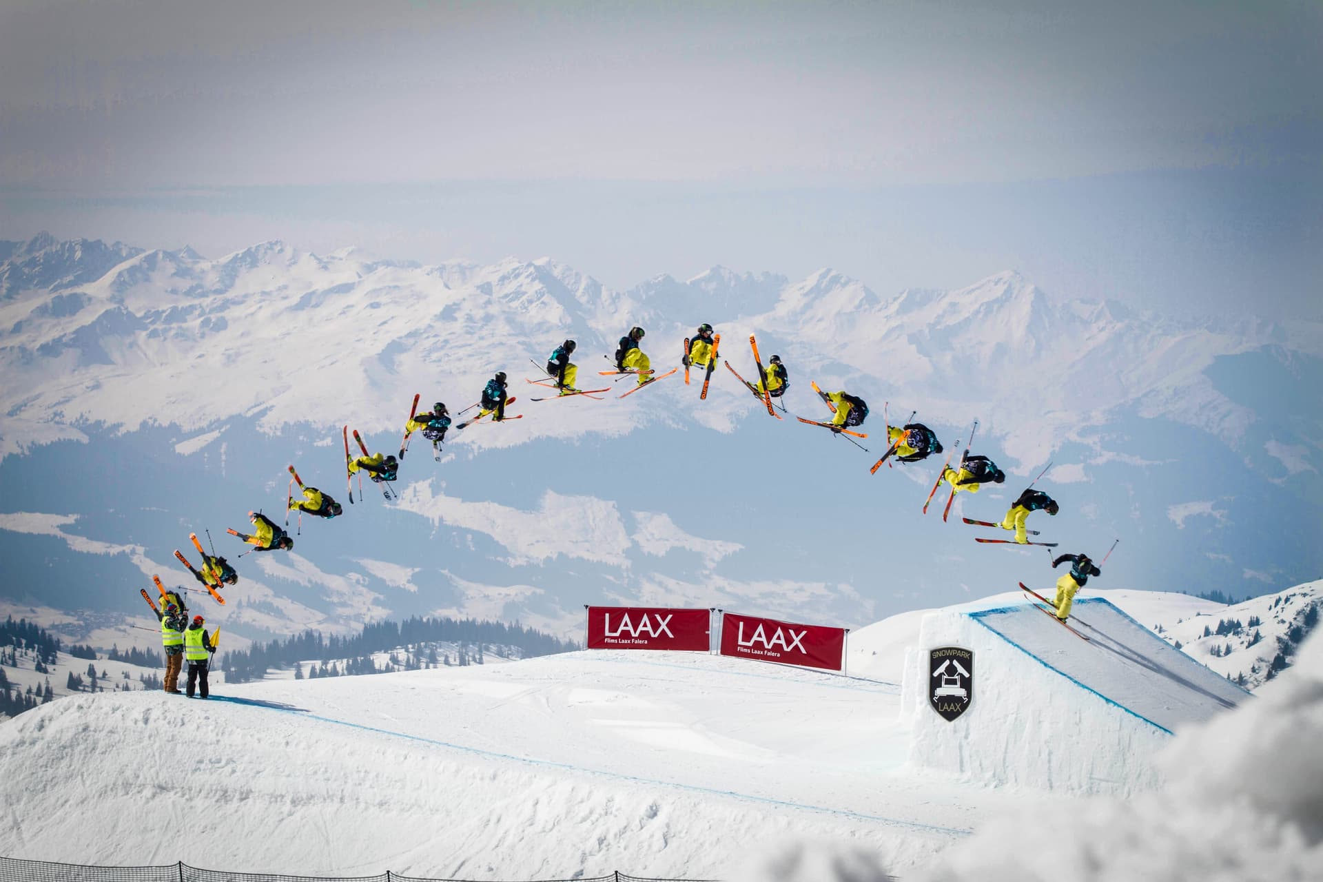 Freestyle skier backflipping over jump in switzerland
