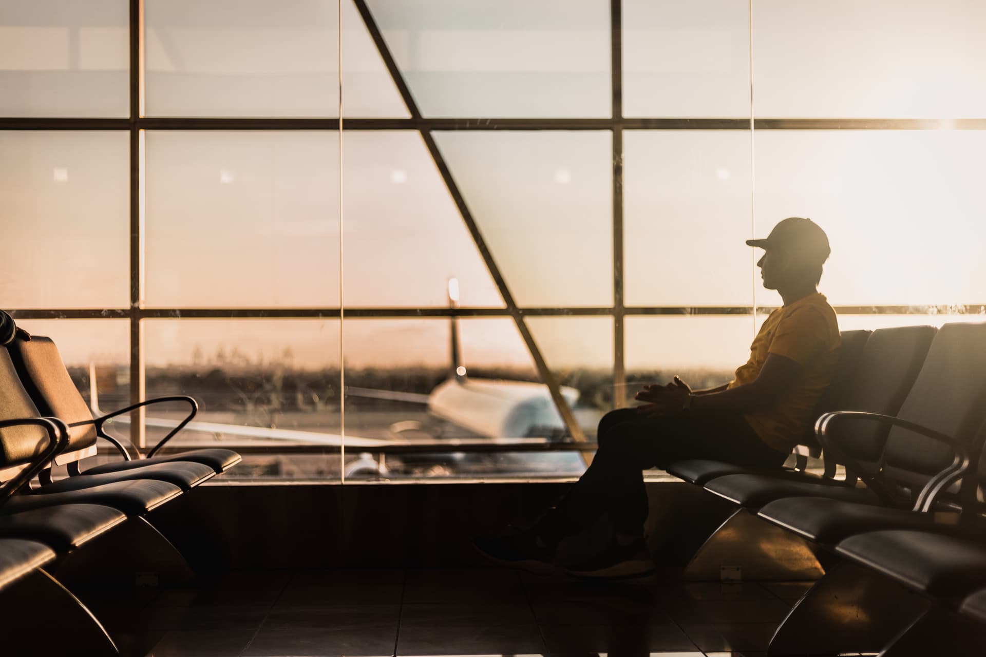 man waits for flight at airport